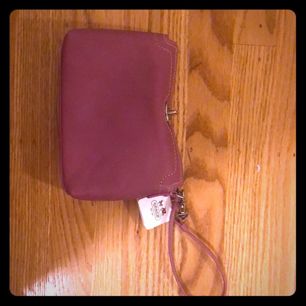 Pink Coach clutch bag with wrist strap